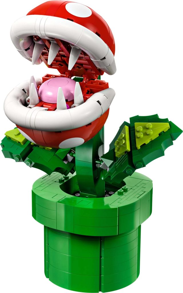 A LEGO® Super Mario™ Piranha Plant [71426] model from the Mario video game series, featuring a red head with white spots, sharp teeth, and green leaves emerging from a classic green pipe base.